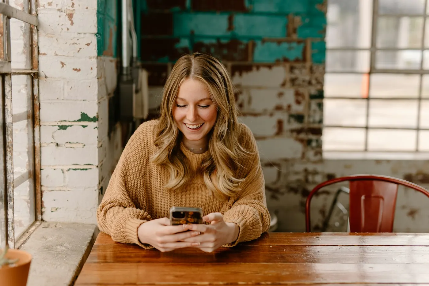 A woman checking her phone at a table